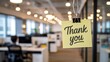 © Fatimazahra7788356 - Thank you note hanging in a modern office to express appreciation and gratitude