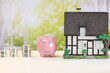 © PhamHong - Piggy Bank, Coins and Model House for Home Savings and Property Investment