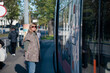 © MexChriss - Woman waiting at tram station in city