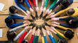 © Digion - Diverse group of students sitting around a table connecting their hands in a circle to represent teamwork and cooperation in an academic classroom environment while promoting community and