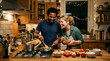 © Digion - A joyful couple enjoys preparing a healthy dinner together in their wooden kitchen while laughing and talking about their day at home during the evening hours while using fresh seasonal