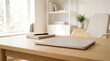 © NorthStar Creations - Minimalistic workspace with a laptop and stationery on a wooden table.