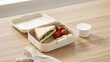 © happie - Off white lunchbox with sandwich and fruit on oak desk – Suitable for back to school meal planning, healthy eating, or kids food.