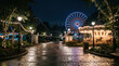 © Tharadon - Empty amusement park pathway glowing at night