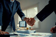 © amnaj - Businessmen shaking hands making agreement in office