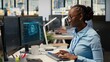 © DC Studio - Portfolio manager uses AI technology to evaluate capital allocation from economic charts, with an African American woman applying machine learning research to support growth decisions and strategy.