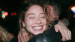 © BlackBridge Media - Joyful Young Woman Hugging Friend at Night Party