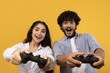 © Prostock-studio - Smiling Young Multiracial Couple, Woman And Man, Engaged In Playing Video Games Together At Home. Joyful Atmosphere In Studio Setting While Enjoying Their Favorite Gaming Experience, Entertainment