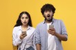 © Prostock-studio - Surprised Expressions From Young Couple, Male And Female, In Their 20s Or 30s, Holding Smartphones And Looking At Screens With Shocked Faces, In A Studio Setting. Digital Communication Concept.