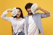 © Prostock-studio - Smiling Young Couple, One Male And One Female, Celebrating While Holding Cash In Front Of Yellow Background, Expressing Joy And Excitement At Studio. Business Concept.