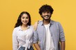 © Prostock-studio - Smiling Young Indian Man And Woman Posing Together, Showing Friendship And Positivity At Studio, Yellow Background. Happy Expressions Reflect Their Joyful Bond And Camaraderie.