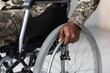 © Prostock-studio - Focused African American Male Veteran In Wheelchair Adjusting Wheel With Hand At Home. Showing Independence And Mobility In Living Space, Emphasizing Healthcare Concept Of Accessibility.