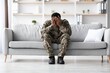 © Prostock-studio - Worried Black Male Soldier Sitting On Couch With Head In Hands, Expressing Stress And Anxiety, In Living Room Setting. Reflecting Mental Health Challenges In Military Veterans.