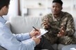 © Prostock-studio - Focused Male African American Soldier In Uniform Engaging In Conversation With Therapist Seeking Assistance In Professional Office Setting. Promoting Mental Health Awareness And Support.