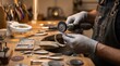 © FrameFlow - Artisan jeweler in protective gloves, holding rotary polishing tool, grinding ornate silver bracelet, working at wooden workbench, craft jewelry photography