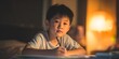 © Habibah - Young boy writing with a pencil at a desk in warm lamplight during evening study time.