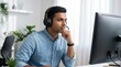 © BrilliantPixels - Serious man wearing a headset with a microphone working in an office during a video call.