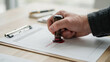 © Shehzad - A person uses a wooden rubber stamp to mark a document as approved on a desk with paper document apply person presses stamp onto authorization