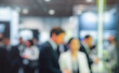 © dwi - Blurred image of an event showcasing a crowd of professionals engaged in conversations. Ideal for business, networking, and exhibition themes.