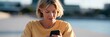 © Andrii Zastrozhnov - Closeup portrait of a woman using a smartphone near waterfront outdoors for social media and lifestyle banner background with modern urban communication design