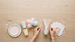 © Thumbs - Party supplies laid out on a wooden table for a celebration