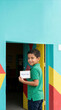 © ArtFocus Studio - Child delivers a small donation at a colorful community center