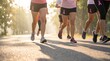 © NoblePix - Group of women running in a race wearing pink ribbons for breast cancer awareness