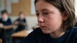 © NoblePix - Young child crying in classroom with tears streaming down face during lesson