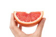 © Atreyee - Human hand presenting a juicy segment of pink grapefruit
