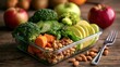 © 69 - Fresh healthy meal prep with broccoli carrot spinach cucumber avocado walnut almond and apple on wooden table with fork ready for lunch or diet plan