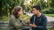 © Arra Vais - Two teens arguing on park bench, upset during disagreement in public park. Young boy and girl intensely discussing, expressing strong emotions, showing communication struggles. Concept teens arguing