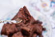 © Austockphoto - stack of chocolate gluten free brownie slices on plate at party