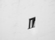 © Binkontan - A window in a black-and-white building. Minimalist architectural style of a building, office building, or house. Urban architectural style, monochromatic gray color.