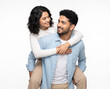 © Someone Cooked Here - Young Indian couple sharing happy eye contact in a piggyback embrace for love relationship family and lifestyle advertising