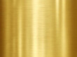 © Surada - Brushed gold metal texture with light reflections. Polished yellow metallic surface background. Luxury golden steel plate for industrial design.