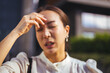 © Dragana Gordic - Stressed Young Woman Rubbing Forehead Outdoors Portrait With Headache And Tired Expression