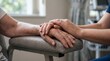 © Maicon - A close-up shot of a younger person's hands gently comforting an elderly person's hands, symbolizing care and support.