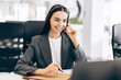 © Maria Vitkovska - Customer support specialist wearing headset helping clients remotely