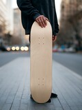 person holding skateboard on city sidewalk