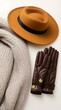 © Napapat - Warm cozy beige knit scarf paired with stylish brown leather gloves featuring decorative buttons and fashionable mustard yellow wide brim felt hat with black band