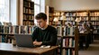 © Fantastic - Young man studying on a laptop at a library table with bookshelves