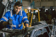 © Quality Stock Arts - Hispanic Latin Indian Male Mechanic Repairing Truck Engine In Auto Service Garage Workshop.