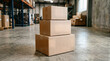 © ZoshPixels - Stack of three cardboard shipping boxes on a warehouse concrete floor