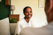 © Davor - Smiling woman talking with client at home