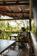 © STOCKERO cr/Stocksy - Remote worker using tablet on tropical balcony