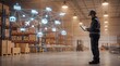 © Razzaq - A warehouse worker in a hard hat uses a tablet to manage logistics and shipping operations with a network of icons superimposed over the scene.