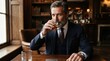 © FryArt - Sophisticated mature businessman drinking whiskey in a luxury bar
