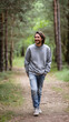 © Createya - Caucasian young adult male walking in forest pathway with casual attire concept of outdoor brands, fitness apps, lifestyle magazines