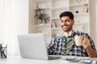 © Prostock-studio - Smiling Young Middle Eastern Man Enjoying Coffee While Working On Laptop At Home Office, Feeling Focused And Productive. Modern Workspace With Cozy Atmosphere, Remote Work Concept.