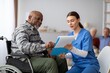 © Prostock-studio - Happy Senior Black Male Patient Engaging With Caring Nurse While Looking At Medical Documents In Clinic Setting. Nurse Assisting Patient With Health Plan And Providing Support For Wellness Concept.